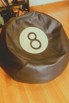 a bean bag chair with the number eight on it sitting on a hard wood floor