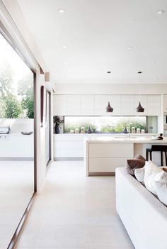 the instagram page shows an open kitchen and living room with lots of white furniture