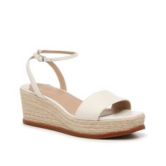 Lauren Ralph Lauren-Leona Wedge Sandal The Leona sandal is the perfect pair for spring and summer soirées! This wedge from Lauren Ralph Lauren is crafted with luxe suedematerial , features a delicate ankle strap, and braided espadrille details. Elegant Wedge Sandals With Heel Strap For Vacation, Cream Wedge Sandals With Heel Strap For Spring, Elegant Wedge Sandals With Ankle Strap For Vacation, Elegant Ankle Strap Wedge Sandals For Vacation, Cream Wedge Sandals With Ankle Strap For Spring, Spring Cream Wedge Sandals With Block Heel, Cream Ankle Strap Wedge Sandals For Spring, Cream Block Heel Wedge Sandals For Spring, White Wedge Sandals With Heel Strap For Spring