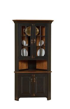 an old fashioned china cabinet with glass doors