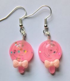 Pink lollipop earrings. With bows and glitter sparkle, view photos close-up for detail.  Silver plated fishhook earwires. Pink Lollipop, Lollipop Earrings, Costume Jewelry Earrings, Sparkle Earrings, Bow Earrings, Pink Glitter, Earrings Silver, Lollipop, Kitsch