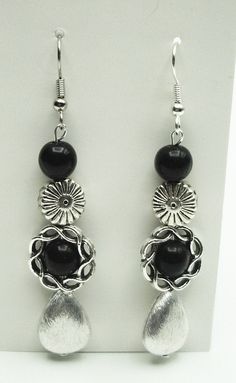 "2-3/4\" silver and black dangle earrings      Intricate designs balance each other beautifully      Pewter teardrops hang at the bottom to finish the look If you prefer a post setting instead of ear wires, please just let me know Ships next business day!" Black Dangle Earrings, Black Earrings Dangle, Silver Flower Earrings, Earrings Flower, Band Bracelet, Black Necklace, Dangling Earrings, Lampwork Glass Beads, Elegant Earrings