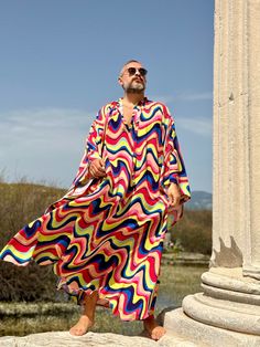 Handmade From start to finish boho wedding kaftan viscose fabric  Men's  caftan Ponchos Billowy dress Unique design rainbow color , multicolor geometric print from Small to 7XL size options Plus size Feel free to Ask for custom made custom made hemline  Gift for him Super comfortable men's clothing  to wear at home or outdoor Comfortable and chic For my all caftans and robes shop link: www.etsy.com/shop/mnouss/ worldwide fast shipping And my new shop link- caftan and more-  www.etsy.com/shop/mai Bohemian Multicolor Summer Thobe, Multicolor Long Thobe For Summer, Multicolor Summer Thobe For Beach, Multicolor Summer Beach Thobe, Multicolor Festival Thobe In Tunic Shape, Long Sleeve Multicolor Kaftan For Vacation, Multicolor Tunic Thobe For Festivals, Oversized Multicolor Kaftan For Vacation, Bohemian Long Sleeve Thobe For Summer