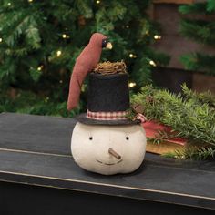 a small snowman sitting on top of a table