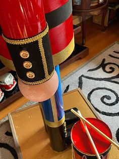 a drum and drumsticks are sitting on the floor