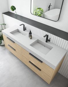 a bathroom with two sinks and a mirror on the wall next to plants in pots