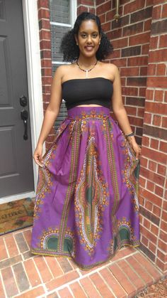 "*African Dashiki Print - Purple and green *Maxi length *3 inches thick waistband *Perfectly pleated waist *Two side pockets *Zipper closure at the back S I Z E C H A R T XS: Waist 25\" - 26\" S: Waist 28\" - 30\" M: Waist 31\"- 32\" L : Waist 33\" - 34\" XL: Waist 35\" - 36\" CUSTOM SIZES (Since these orders use up more fabric, we charge an extra $20). XXL: Waist 37\" - 39\" 3XL: Waist 40\" - 42\" 4XL Waist 43 - 46 Kindly note that due to variations in computer monitors, tablets, and/or mobile Purple Bohemian Maxi Skirt, Bohemian Purple Lined Skirt, Purple Bohemian Lined Skirt, Fitted Bohemian Purple Bottoms, Fitted Purple Lined Maxi Skirt, Long Purple Cotton Skirt, Bohemian Purple Maxi Skirt For Spring, Casual Purple Flared Maxi Skirt, Purple Long Skirt For Festival