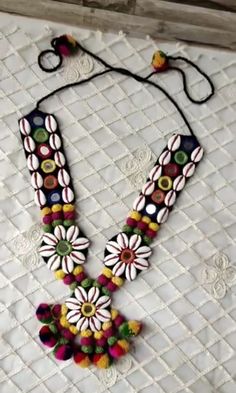 a multicolored beaded necklace with flowers on it