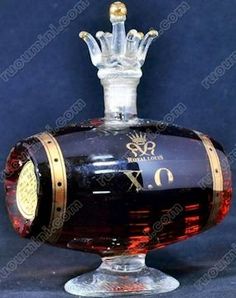 an old fashioned glass bottle with a crown on it's top and the number six