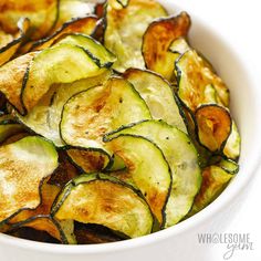 a white bowl filled with cooked zucchini chips