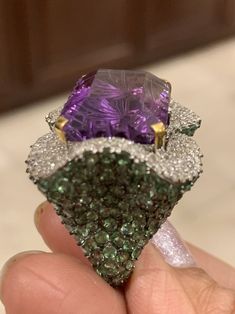 Diamond Amethyst Tsavorite Ring, Amethyst Cocktail ring, Tsavorite Ring, diamond Amethyst Jewelry, Diamond Tsavorite Jewelry Gross Weight 17.74gm 18k Gold- .6gm Single Cut Diamond- 1.45 carat Silver- 10.44 gm Amethyst Tsavorite- amethyst22.37carats 15 by 20 mm green Tsavorite9.68 carats ring face 22 by 26 mm Current size in stock 7.5US but we can make in any size This Gorgeous Amethyst Tsavorite Cocktail ring is Classic and High Fashion. It is crafted with 18k White gold and Silver to reduce cos Luxury Tsavorite Gemstones For Anniversary, Luxury Tsavorite Ring With Gemstone Accents, Green Amethyst Rings In Fine Jewelry Style, Formal Green Amethyst Ring With Accent Stones, Luxury Green Diamond Ring With Gemstone Accents, Formal Green Amethyst Ring With Gemstone Accents, Green Amethyst Ring For Formal Occasions, White Gold Amethyst Diamond Multi-stone Ring, White Gold Multi-stone Diamond Amethyst Ring