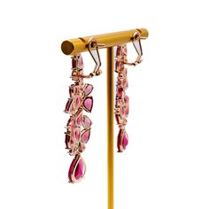 Long earrings can add a touch of elegance and glamour to any outfit, especially when dressing up for a night out. These beautiful fuchsia earrings are a perfect example of how accessories can enhance your overall look. The bold color of these earrings will make them stand out and draw attention to your face, while the length will add a sense of drama and sophistication. When wearing long earrings, it's important to keep the rest of your jewelry minimal so that the earrings can be the star of the Luxury Red Earrings For Party, Luxury Red Party Earrings, Luxury Dangle Clip-on Earrings For Party, Ruby Chandelier Drop Earrings For Party, Glamorous Clip-on Earrings For Evening, Ruby Drop Earrings For Party, Glamorous Evening Clip-on Earrings, Ruby Drop Earrings For Bridal Party, Elegant Ruby Bridal Earrings For Party