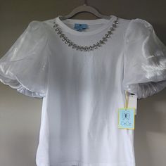 Designed By Cece Puff-Sleeve Style Top In Angelic White Color >> Feel Like An Angel Or A Princess In This 1 ! Or, Be Both !! You Will Want To Flutter Your Wings With The Chic Design Of The Sleeves. Quite Beautiful..... + Jewel-Embellished Front + Clear Stones With Silver-Setting Size: Small Dimensions: Arm P To Arm P = 18.5" Length: 24" Approx Fly Away Angel Puff Sleeve + A N G E L I C = F E E L B E A U T Y ^ S E E Beauty > Angel Sleeve Shirt, Clear Stone, An Angel, A Princess, White Top, The Chic, White Tops, Chic Design, Sleeve Styles