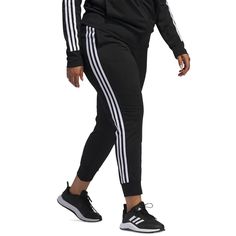 Keep active in these fitted Women's Essentials Warm-Up Slim Tapered 3-Stripes Track Pants from adidas, designed for zero distractions with a close, tapered fit that stays securely in place. The elastic waist features a convenient drawcord to customize coverage and comfort, while front pockets stash music players or cash. Breathable polyester fabrication keeps you cool whether climbing stairs or dropping low into squats, with flatlock seams preventing chafing. Subtle 3-Stripes branding adds style to this versatile workout wardrobe essential. Adidas Stretch Sweatpants For Jogging, Adidas Stretch Joggers For Jogging, Adidas Sporty Joggers For Training, Casual Three Stripes Joggers For Workout, Athleisure Joggers With Three Stripes For Workout, Adidas Sporty Joggers For Sports, Stretch Athleisure Joggers With Three Stripes, Sporty Stretch Pants With Three Stripes, Stretch Athleisure Pants With Three Stripes