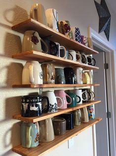 a wall shelf filled with lots of coffee mugs