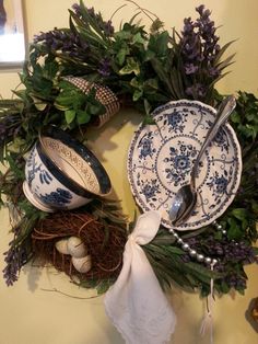 a wreath with blue and white dishes on it