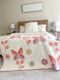 a bed with a quilt on top of it