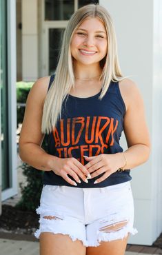 Rep your school everywhere you go with our Auburn Zeppelin Tank Top! It is full length with a flattering scoop neckline. The material is very lightweight to keep you cool all game long. This tank also features the iconic Auburn colors to show some love for your favorite school. Pair with your favorite shorts and strappy sandals. Details: *OFFICIALLY LICENSED* Auburn Tigers Full Length Scoop Neckline Lightweight 100% Cotton True to Size Emma is wearing size Small Casual Tank Top For Game Day In Summer, Casual Summer Tank Top For Game Day, Casual Cotton Tank Top With Scoop Back, Casual Cotton Activewear With Scoop Neck, Casual Scoop Neck Tank Top With Letter Print, Sporty Crew Neck Tank Top For College, Casual Summer Activewear With Scoop Back, Casual Sports Tank Top With Team Name, Game Day Cotton Racerback Tank Top