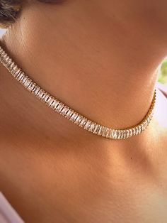 "\"18k Gold Plated Brass Tennis Choker with Cubic Zirconia, 15-3/4 inch (40 cm)\" Description: Elevate your accessory game with our exquisite tennis choker, crafted from high-quality brass and lavishly plated in 18k gold. This stunning piece is adorned with brilliantly sparkling cubic zirconia, set in a classic tennis style that wraps elegantly around the neck. At a length of 15-3/4 inches (40 cm), this choker is designed to offer a snug yet comfortable fit, making it an ideal choice for both everyday elegance and special occasions. The harmonious blend of the cubic zirconia's sparkle with the warm hue of the gold plating creates a sophisticated and timeless look. This tennis choker is not just a piece of jewelry; it's an expression of refined taste and luxury. Whether you're looking to ad Luxury Gold Plated Timeless Diamond Necklace, Luxury Yellow Gold Party Choker, Luxury Gold Tennis Necklace With Prong Setting, Luxury Round Yellow Gold Tennis Necklace, Gold Tennis Necklace With Clavicle Chain For Party, Gold Clavicle Chain Tennis Necklace For Party, Gold Crystal Tennis Necklace For Party, Gold Cubic Zirconia Tennis Necklace For Party, Gold Tennis Choker Necklace As Gift