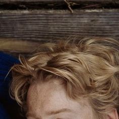 a close up of a person with curly hair