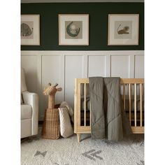 a baby's room with two cribs and three pictures on the wall