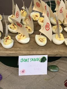 deviled eggs with sail boats on them are ready to be served at an easter party