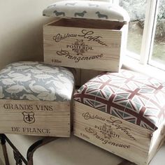 four wooden boxes sitting on top of a table next to a window with the words grand vins written on them