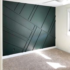 an empty room with green paneling on the wall and carpeted floor in front of it