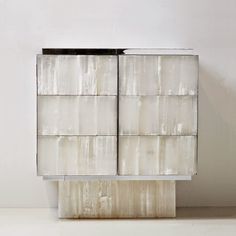 a white cabinet sitting on top of a table