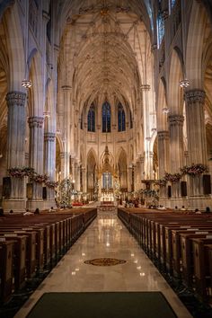 the inside of a large cathedral with pews