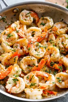 cooked shrimp with parsley in a skillet