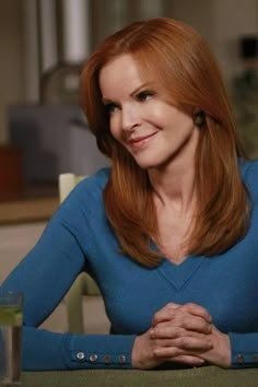 a woman with red hair sitting at a table