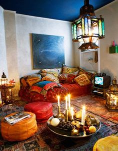 a living room filled with lots of furniture and candles