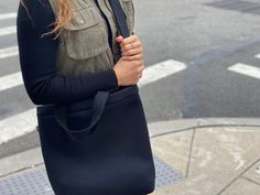 You are going to love our Town Bag! A chic, easy-to-wear crossbody perfect for carrying your daily essentials! Seriously tricked out with an inside slip pocket. It has a hearty snap at the top. Carry it by the handles or wear it as a crossbody for extra support. This is the perfect bag for everyday, on-the-go!Features: Zipper Compartment, Inner Slip Pocket, Snap Closure, Comfort Handles, Adjustable Crossbody Strap, 15" x 13" x 3".Details• Made in United States• Style: QK-TOWN-NBLACK Reversible Crossbody Travel Bag, Reversible Crossbody Shoulder Bag For Daily Use, Chic Everyday Bags With Cell Phone Pocket, Chic Everyday Bag With Cell Phone Pocket, Casual Reversible Bag For Daily Use, Versatile Everyday Shoulder Bag With Cell Phone Pocket, Reversible Shoulder Bag For On-the-go, Versatile Shoulder Bag With Cell Phone Pocket, Everyday Fall Standard Backpack