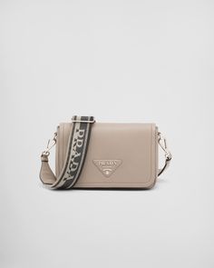 Clay Grey Leather Shoulder Bag | PRADA Classic Saffiano Leather Bag With Logo Hardware, Beige Leather Bags With Logo Hardware, Rectangular Calf Leather Shoulder Bag With Logo Hardware, Everyday Flap Shoulder Bag With Logo Hardware, Luxury Beige Shoulder Bag With Logo, Logo Hardware Flap Shoulder Bag, Designer Calf Leather Shoulder Bag With Logo Hardware, Leather Shoulder Bag With Logo Hardware For Travel, Luxury Flap Shoulder Bag With Logo