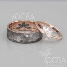 two wedding bands with flowers and leaves on them, one in gold and the other in silver