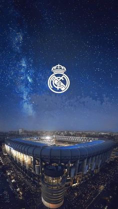 an aerial view of the soccer stadium at night with stars in the sky above it