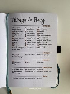 an open notebook with the words things to buy on it