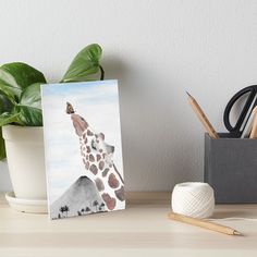 a painting of a giraffe standing on top of a mountain art board print