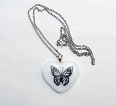 Introducing our beautiful white heart with black butterfly fused glass heart necklace! Perfect for any occasion, this stunning piece features a unique and intricate design that will surely capture everyone's attention. It comes on a 20-inch steel chain or an 18-inch black cord, giving you the option to wear it as a statement piece or as a simple, chic accessory. Handcrafted using the finest quality materials, this necklace is both durable and stylish. It's an excellent gift for your loved ones o Glass Heart Necklace, Celestial Necklace, Key To My Heart, Small Gift Boxes, Black Butterfly, Simple Chic, Glass Heart, Chic Accessories, White Heart