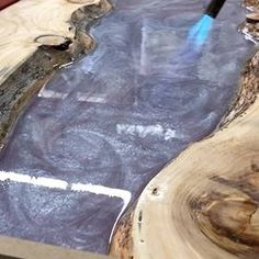 a close up of a piece of wood on a table with a pen in it