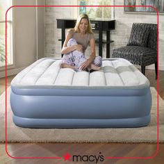 a woman is sitting on an inflatable mattress