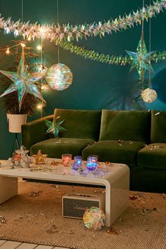 a living room filled with lots of furniture and lights hanging from the ceiling above it