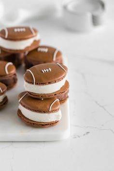 some football cookies are sitting on a white board and ready to be eaten for the game