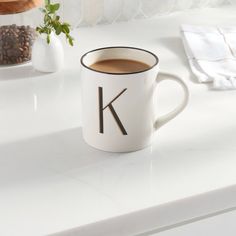 a cup of coffee sitting on top of a white counter