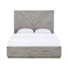 a bed with a wooden headboard and white sheets