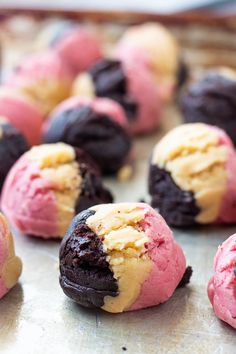 chocolate and raspberry cookie doughnuts are on a baking sheet, ready to be eaten