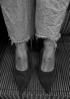 a woman's feet with small tattoos on her left ankle and right foot in black - and - white