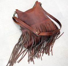 Bohemian fringe bag, cognac leather fringe bag, cognac brown boho bag, festival bag, leather crossbody, handmade leather bag This gorgeous bohemian style bag is crafted with a high quality suede leather and a cowchide leather. It has a top zip closure, and includes an inside pocket. It's cross body feature makes it suitable for a day or night occasion. Light in weight and unique. It is the perfect bag for every season. We use soft genuine leather. This bag is perfect as your everyday bag, which Brown Fringe Hobo Shoulder Bag, Brown Fringe Tote Shoulder Bag, Brown Tasseled Hobo Bag, Brown Tasseled Crossbody Hobo Bag, Brown Crossbody Hobo Bag With Tassels, Bohemian Brown Shoulder Bag With Fringe, Festival Brown Hobo Bag With Fringe, Brown Fringe Hobo Bag For Festival, Festival Brown Fringe Hobo Bag