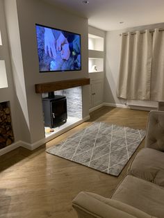 a flat screen tv mounted to the side of a wall next to a fire place